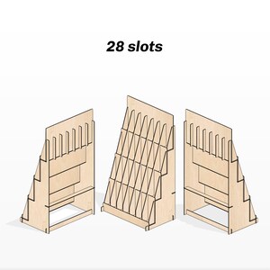 May include: A wooden magazine rack with 28 slots. The rack is made of plywood and has a natural wood finish. It is designed to hold magazines, brochures, or other printed materials. The rack is shown from three different angles.