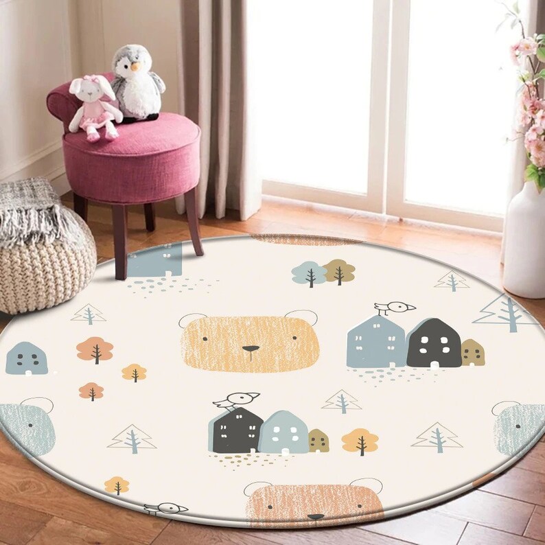 May include: A round, cream-colored rug with a repeating pattern of brown bears, houses, and trees. The rug has a light brown border.