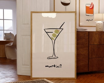 May include: A framed print of a martini glass with olives and the text "martini?" in black lettering. The print is on a white background and has a wooden frame.