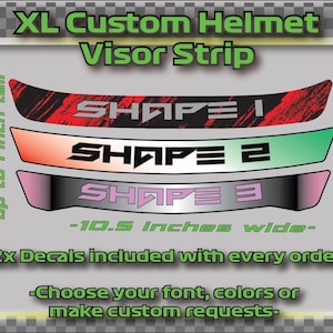 May include: Three different designs for a custom helmet visor strip. The designs are black with white text that says "SHAPE 1", "SHAPE 2", and "SHAPE 3". The text is in a bold, blocky font. The strips are up to 1 inch tall and 10.5 inches wide. Two decals are included with each order. You can choose your font, colors, or make custom requests.