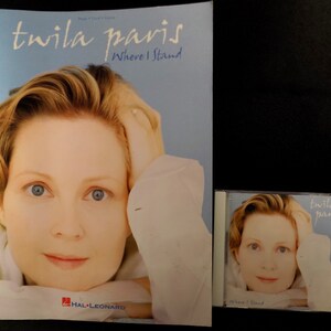 May include: A blue and white CD and booklet set featuring a photo of Twila Paris. The title of the album is "Where I Stand".