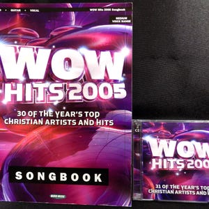 May include: A songbook and CD set titled "WOW Hits 2005" with a purple and pink abstract design. The songbook reads "30 of the Year's Top Christian Artists and Hits." The CD case reads "31 of the Year's Top Christian Artists and Hits."