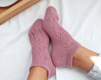 May include: A pair of pink ankle socks with a delicate lace pattern. The socks are made of a soft, breathable material and are perfect for everyday wear.