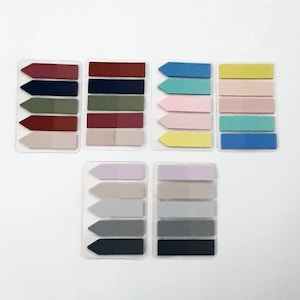 May include: Set of colorful sticky note flags with arrow tabs. The flags are in various colors, including red, green, blue, yellow, pink, and gray. Each set has five flags.
