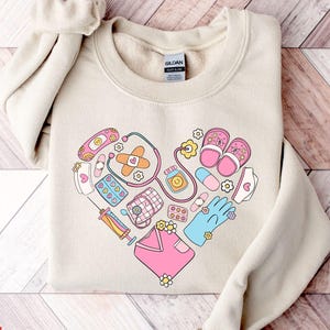 Cute Medical Icon Pattern Sweatshirt, Healthcare Professionals Graphic Sweatshirt, Medical Themed Heart Design Hoodie