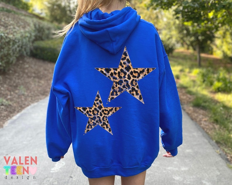 May include: A royal blue hoodie with two leopard print star designs on the back. The hoodie has a hood and long sleeves. The text "VALEN TEEN design" is visible in the lower left corner.