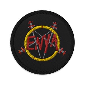 May include: Black embroidered patch with a yellow circle and the word "Enya" in red letters inside. The circle is surrounded by four red figures with swords.