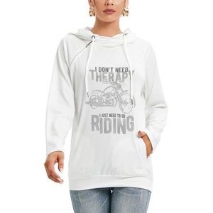 May include: White hoodie with a drawstring hood and a kangaroo pocket. The front of the hoodie features the text "I DON'T NEED THERAPY I JUST NEED TO GO RIDING" with a motorcycle graphic in gray.