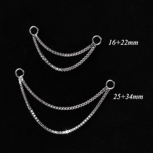 May include: Two silver-toned chain connectors with a double-strand design. One connector is labeled "16+22mm" and the other is labeled "25+34mm". The chains are suspended against a black background.