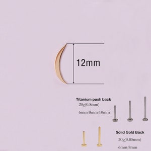 May include: A gold crescent moon earring top measuring 12mm in height. The image includes text for titanium push backs in 20g 0.8mm with 6mm, 8mm, and 10mm lengths, and solid gold backs in 20g 0.85mm with 6mm and 8mm lengths for body jewelry.