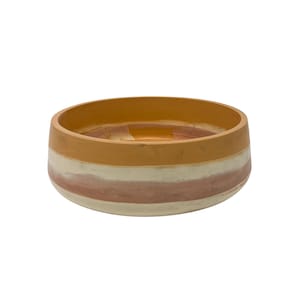 May include: A round ceramic bowl featuring a horizontal striped pattern in shades of mustard yellow, cream, and muted terracotta. The interior of the bowl is a solid mustard yellow, while the exterior displays a smooth, matte finish with distinct color bands.