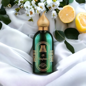 May include: A green glass bottle with a gold top and label. The bottle is labeled "Al Rayhan Attar Collection Eau de Parfum 100ml".