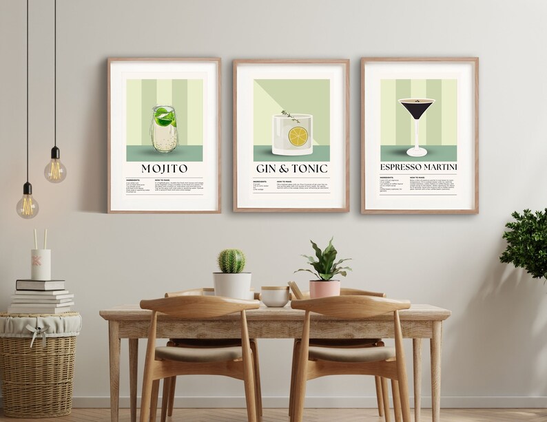 May include: Three framed art prints featuring cocktail illustrations. The prints showcase a Mojito, Gin & Tonic, and Espresso Martini, each with a recipe. The artwork has a light green and beige color scheme, with wooden frames.
