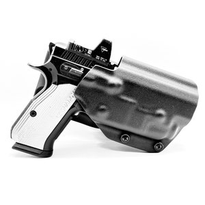 May include: A black handgun with a white grip is holstered in a black leather holster. The holster has a red dot sight attached to the top.