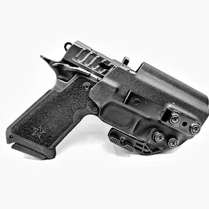 May include: A black handgun with a black holster. The holster has a clip on the side and multiple screws.