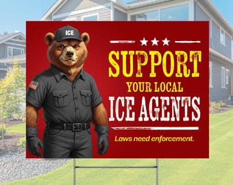 May include: A rectangular yard sign with a red background featuring a brown bear wearing a black uniform, gloves, and a cap labeled ICE. The text reads SUPPORT YOUR LOCAL ICE AGENTS and Laws need enforcement, with three white stars above the text.