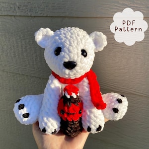 May include: White crocheted polar bear wearing a red scarf and holding a crocheted chocolate bar.  PDF Pattern.
