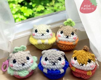 May include: Five crocheted amigurumi squirrel plushies in different colours and outfits. Each squirrel is sitting in a crocheted basket or cup. The squirrels are wearing different coloured outfits, including blue, green, yellow, orange, and red. The plushies are sitting on a wooden table. The text "PDF Pattern" is visible in the top right corner of the image.