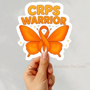 May include: Orange butterfly sticker with an orange ribbon in the centre. The sticker says "CRPS Warrior" and "Invisibly Out Loud" in a white font.