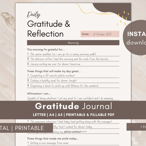 May include: Printable gratitude and reflection journal with a brown and gold design. The journal includes sections for daily gratitude, three things that will make your day great, and an affirmation. The journal is dated October 12, 2022.