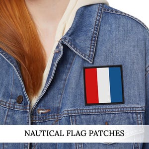 May include: A denim jacket with a rectangular patch featuring a vertical tricolor design of red, white, and blue. The text "NAUTICAL FLAG PATCHES" is displayed at the bottom of the image.