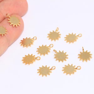 May include: Ten gold-colored sun charm pendants with a loop for attaching to jewelry or other crafts.