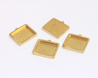 May include: Four gold-coloured square pendant trays with a textured surface. Each tray has a small loop at the top for attaching a chain or cord. The trays are empty and ready for customisation.