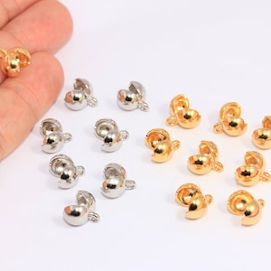 May include: A collection of 15 gold and silver metal clasps for jewelry making. The clasps are round and have a small loop on one side. They are perfect for adding a finishing touch to necklaces, bracelets, and other jewelry projects.