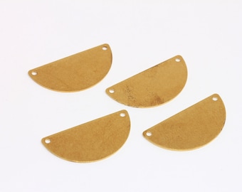 May include: Four gold-colored metal half-circle shapes with holes on either side. The shapes are slightly textured.