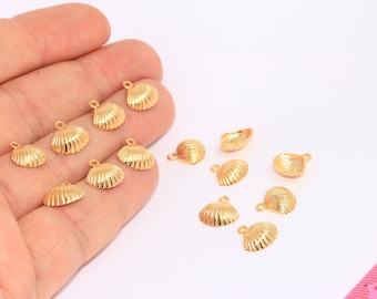 May include: A collection of 12 gold-colored seashell charms with a loop for attaching to jewelry or other crafts.