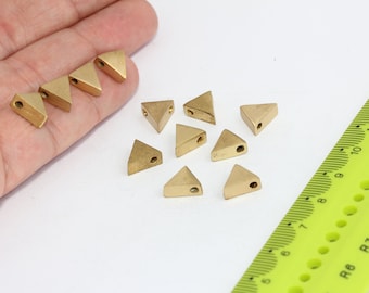 May include: Ten gold triangle-shaped metal beads with a hole in the center. The beads are approximately 1/2 inch in size.