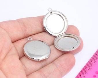 May include: Two silver locket pendants with a hinged opening. The lockets are round and have a smooth, shiny finish.