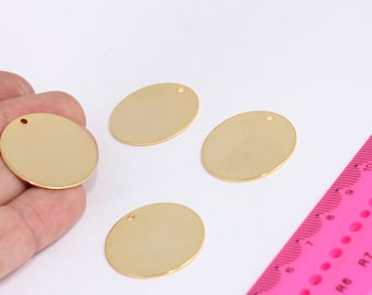 May include: Four gold-colored metal circles with a small hole in the center. The circles are about 1 inch in diameter.