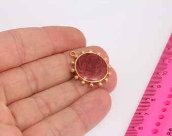 May include: Gold-toned pendant with a round, red, marbled design. The pendant has a small loop at the top for attaching to a chain.