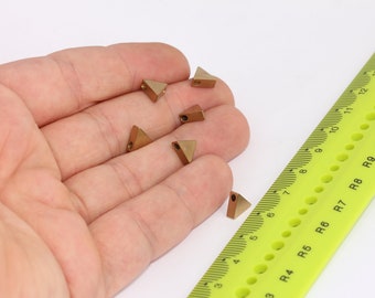 May include: Six gold-colored triangle-shaped metal beads with a hole in the center. The beads are about 1/2 inch in size.