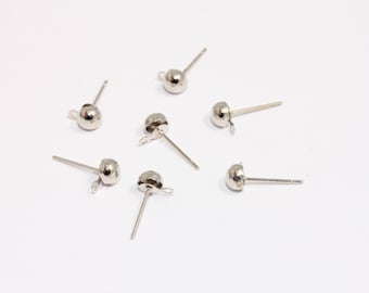 May include: Six silver earring posts with a small ball at the top. The posts are designed for attaching earrings.