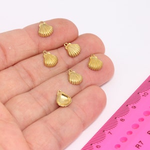 May include: Six gold-coloured seashell charms with a loop for attaching to jewellery or other crafts.