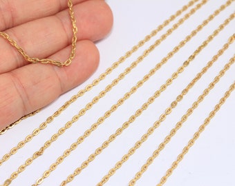 May include: Multiple strands of gold-coloured chain, likely for jewellery making, are laid out on a white surface. The chain is a delicate, oval-link style.