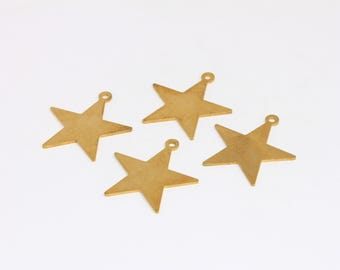 May include: Four gold-colored star charms with a loop at the top for hanging. Each star has five points and a slightly textured surface. The charms are arranged on a white background.