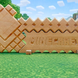 May include: A light brown wooden sign featuring the Minecraft logo, carved into the wood. The sign has a pixelated design, with a matching wooden stand. The background is a pixelated landscape.