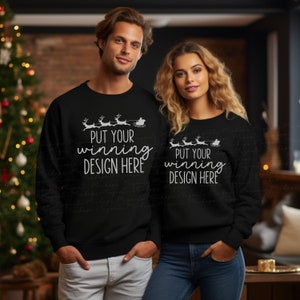 Puede incluir: Dos sudaderas negras con un diseño blanco de Papá Noel en un trineo tirado por renos. El texto en las sudaderas dice "Put your winning design here".