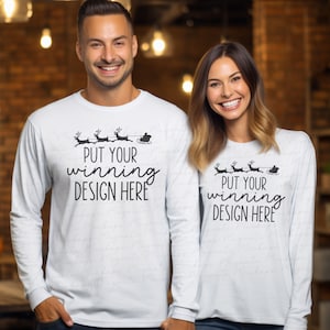May include: Two white long-sleeve shirts with a black graphic of Santa Claus in a sleigh pulled by reindeer. The text on the shirts reads "Put your winning design here".