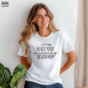 May include: White t-shirt mockup with the text "PLACE YOUR WINNING DESIGN HERE" and a small floral design above the text.