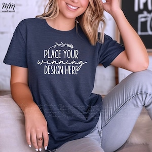 May include: A navy blue t-shirt with a white design that says "Place your winning design here" with a small floral graphic above the text.