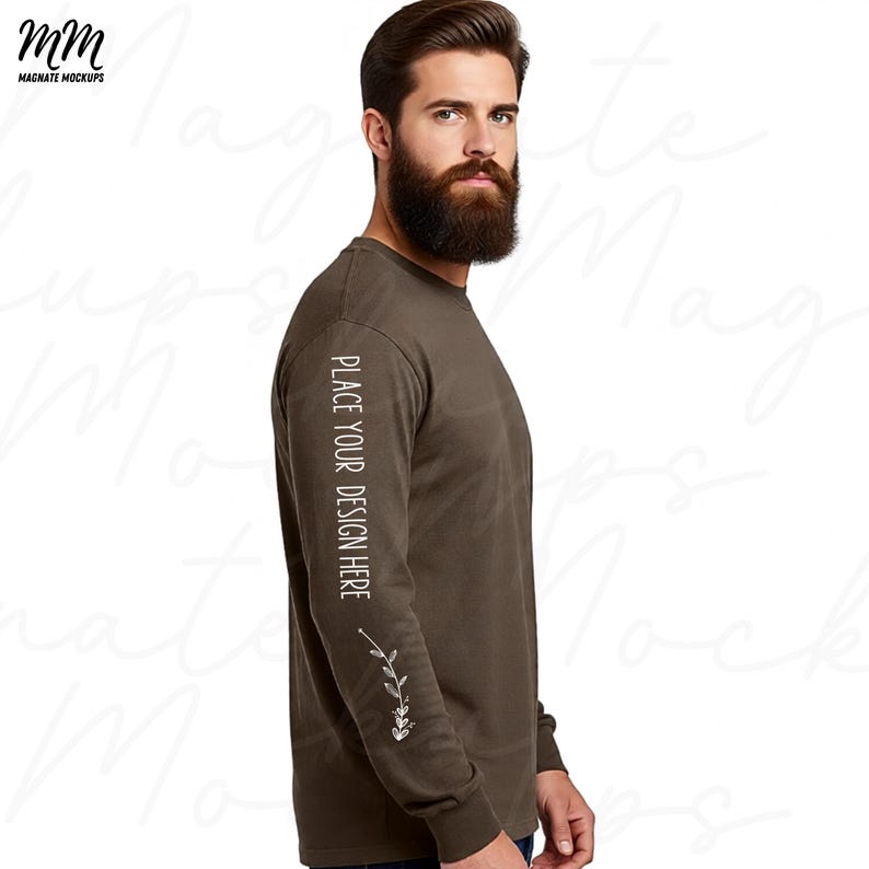 May include: A long-sleeve olive green shirt with the text "PLACE YOUR DESIGN HERE" printed vertically on the left sleeve. A floral design is below the text. The shirt is a mock-up for design placement.