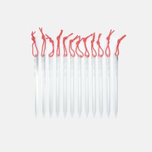 May include: A set of 14 red and white tent pegs, also known as tent stakes, for securing a tent to the ground.