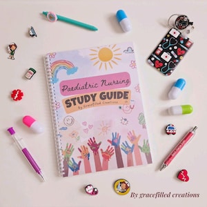 Puede incluir: Una "Guía de estudio de enfermería pediátrica" encuadernada en espiral con un diseño de arcoíris y sol, rodeada de bolígrafos, gomas de borrar con forma de píldora y alfileres decorativos. La guía presenta ilustraciones de manos coloridas y el texto "By Gracefilled Creations."