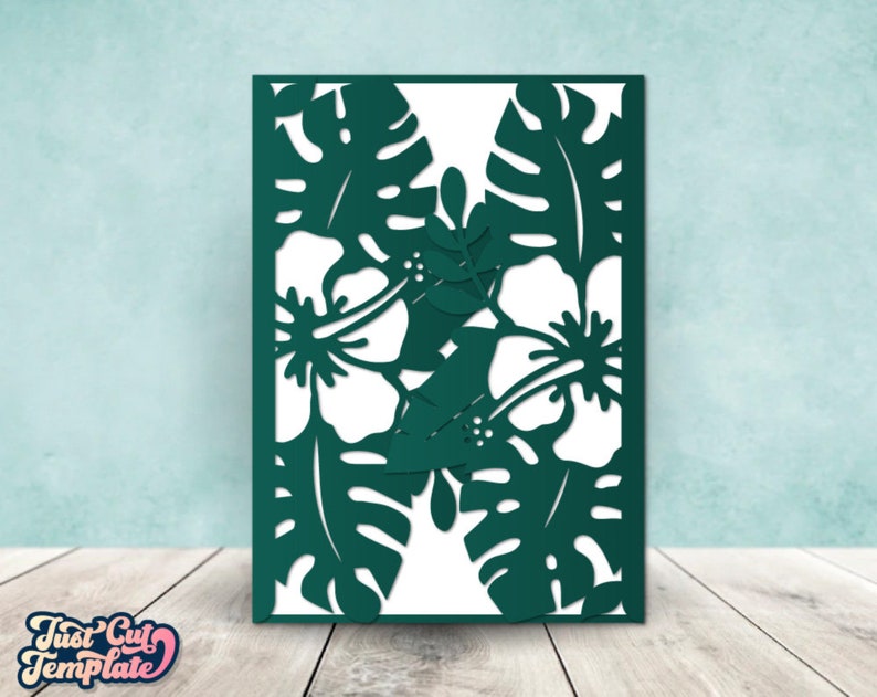 May include: A digital cut file design featuring tropical flowers and leaves. The design is in a dark green color and is perfect for creating cards, invitations, or other paper crafts.