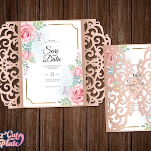 May include: A laser cut wedding invitation with a delicate floral design. The invitation is in a rose gold color and features a floral pattern with pink roses and green leaves. The text on the invitation reads "Sari and Datu" and includes the wedding date.