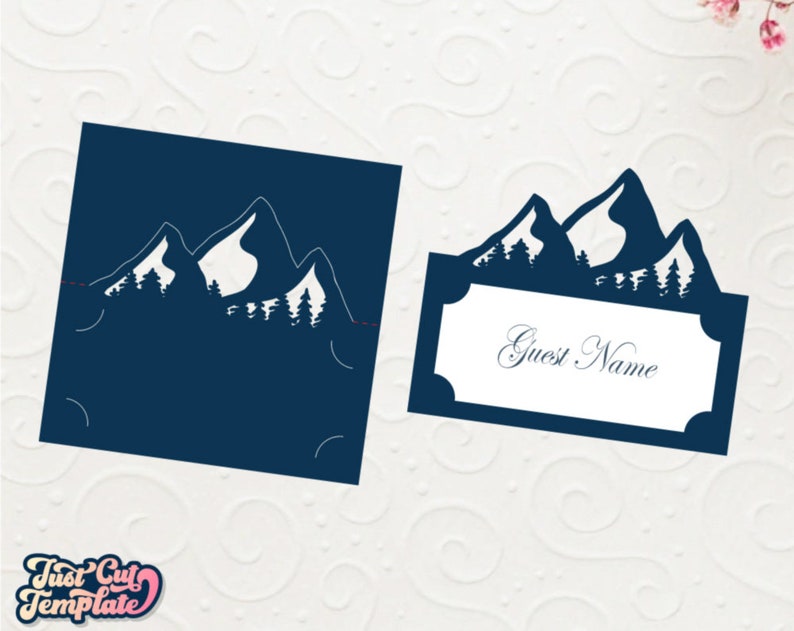 May include: A blue mountain silhouette with trees, a place card with the text "Guest Name" for a wedding or party.